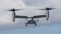 a military aircraft flying in the sky with propellers